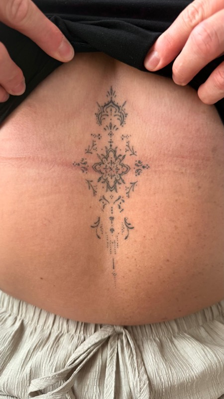 Healed ornamental sternum tattoo